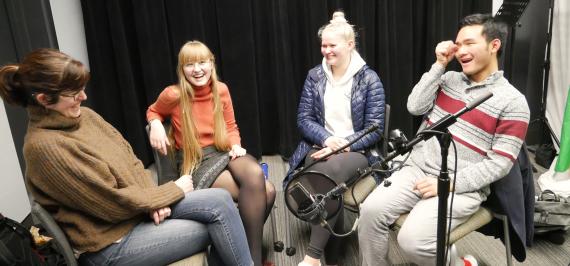 Amanda Doxtater, Blue Palmer, Fanny Mestä-Tokila, and Bill Cheung-Daihe laugh as they sit around the microphone.