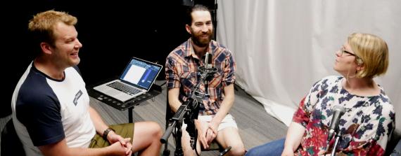 Kristian Næsby, Colin Connors, and Dr. Olivia Gunn laugh and talk into microphones in the recording studio.