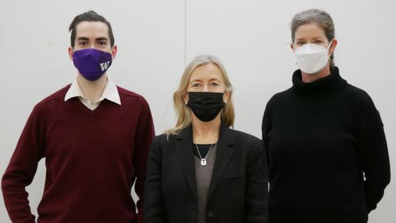Colin Connors, Helene Larsson Pousette, and Amanda Doxtater pose with covid masks covering their faces.