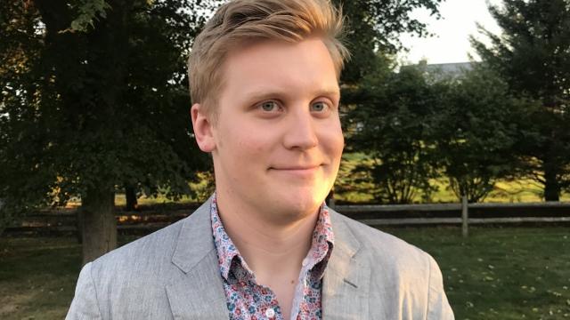 Dr. Matt Boutilier poses outside in a park.
