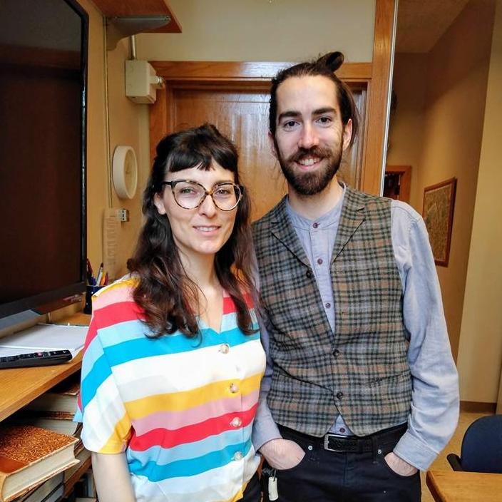 Saskia Vogel poses with Colin Connors in a university meeting room.