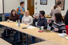 Eeva Kuikka giving talk at table of people
