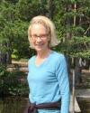 Connie standing on the dock, enjoying the sunshine.