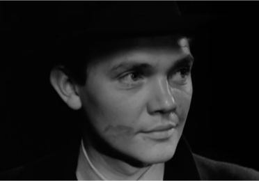 black & white photo of actor with a lipstick mark on his cheek