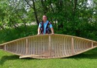Wayne Valliere with a birchbark canoe.