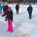 Middle school students prepare to throw snowsnakes on a frozen lake.